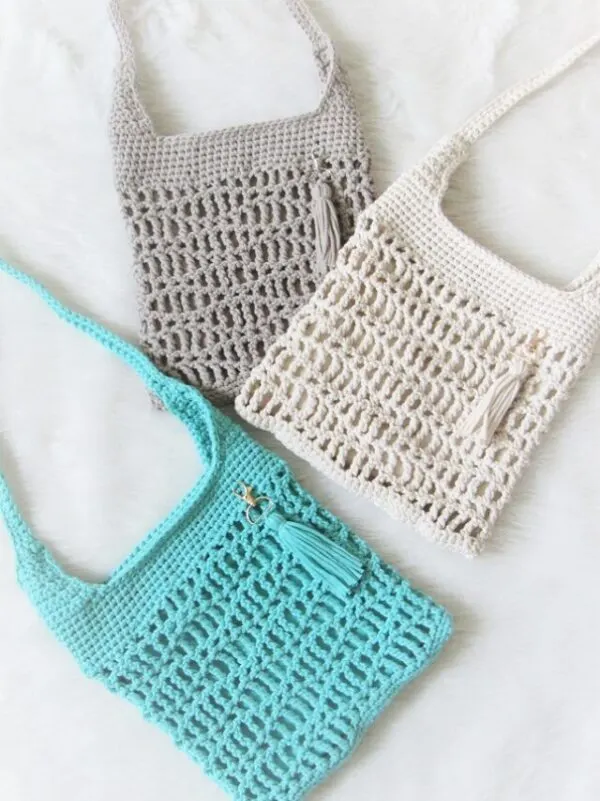 Bag made using the how to crochet a bag for beginners step by step tutorial in blue, cream and gray color