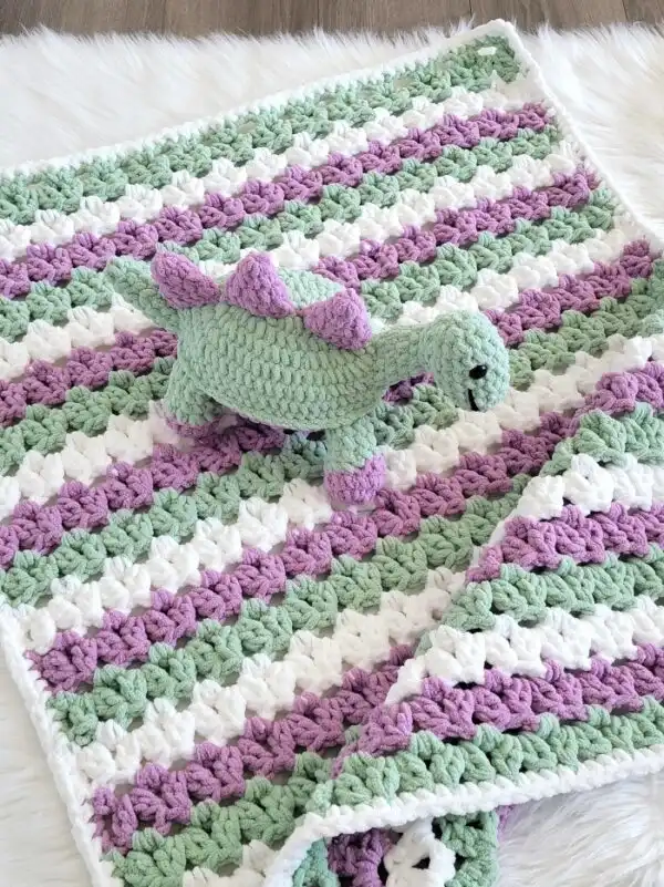 Crochet Dinosaur plushie on matching blanket