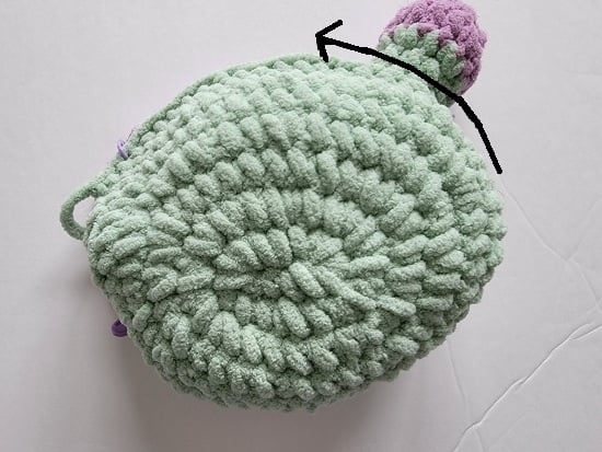 Arrow showing to start slip stitching from back to front