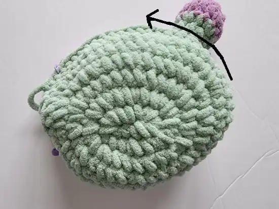 Arrow showing to start slip stitching from back to front