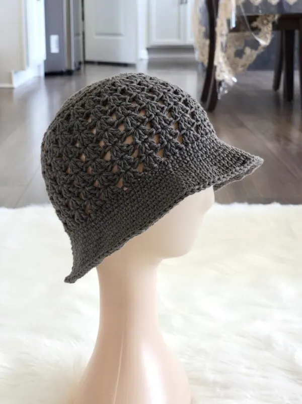 summer corchet bucket hat in gray color on a mannequin head