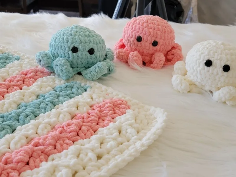 crochet octopus in peach, blue and cream with matching blanket