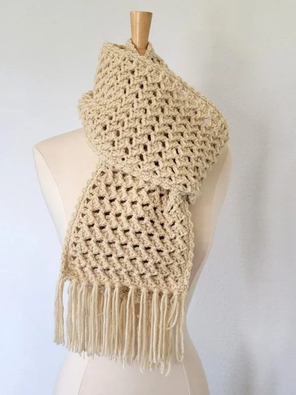 Cream crochet scarf wrapped around a mannequin neck