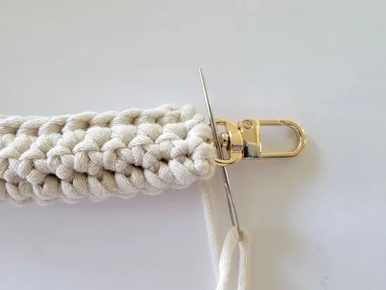 Whip stitching the strap to the golden buckle
