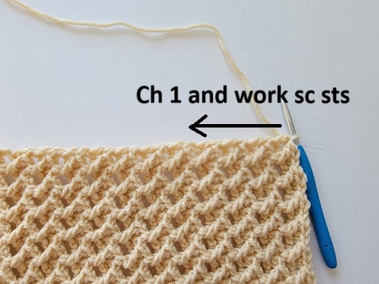 Arrow showing where to distribute sc stitches