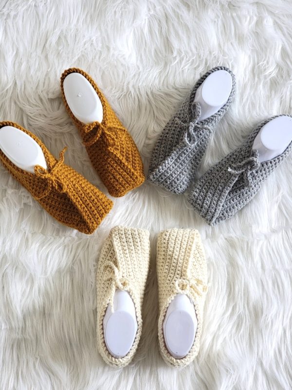 3 pair of women's crochet slippers in cream, yellow and gray.