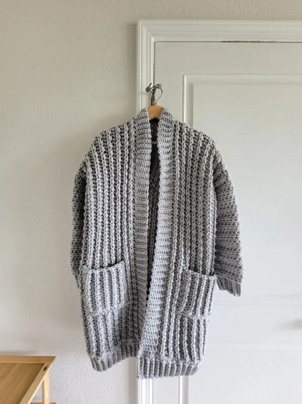 Finished duster cardigan on a hanger