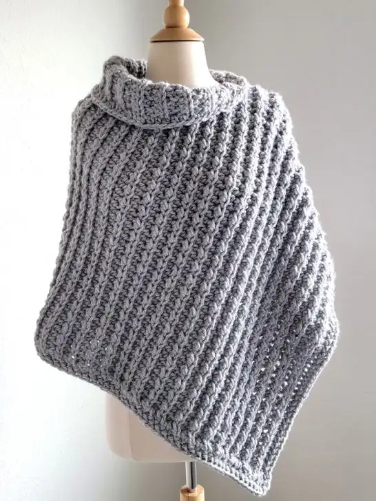 gray chunky crochet poncho on a mannequin