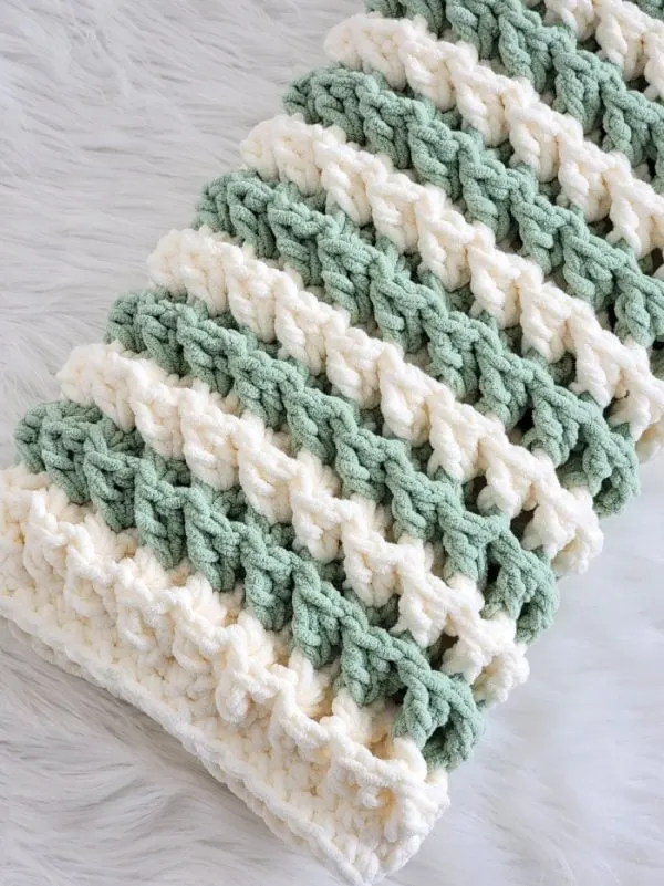 Crochet chunky blanket in sage nae cream color folded