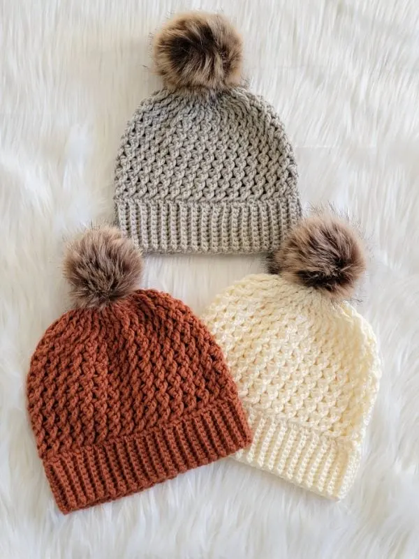 finished crochet beanies made in orange, gray and cream colors