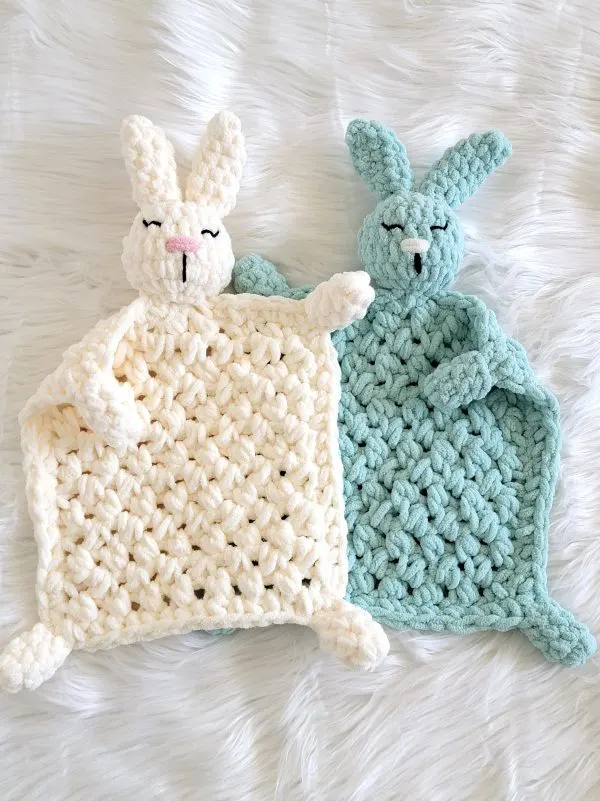 Blue and cream crochet bunny loveys placed side by side