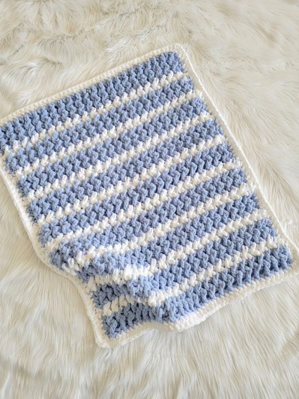 Finished blue crochet blanket with white stripes