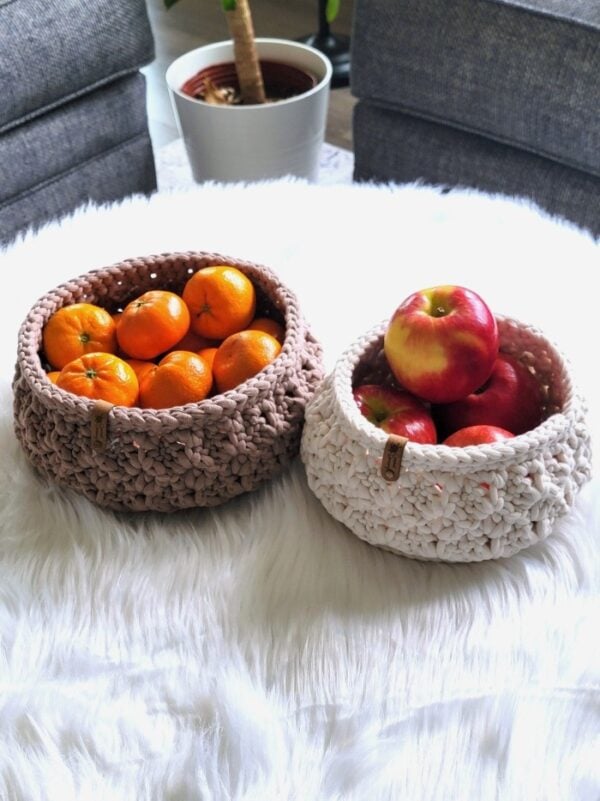 Cream and brown crochet baskets with apple and orange in them