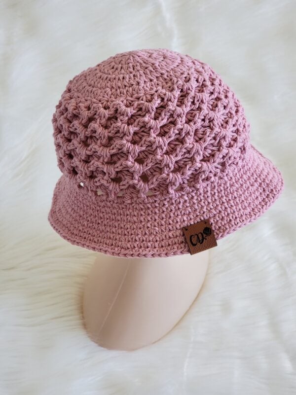 Pink crochet bucket hat on a mannequin head