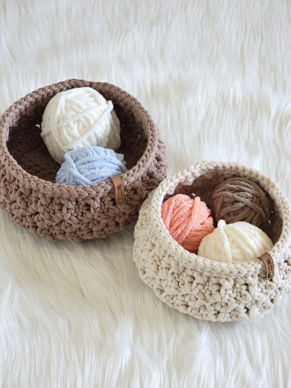 Crochet baskets holding yarn balls in them