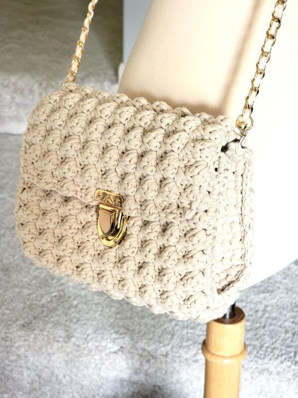 Cream crochet purse on a mannequin