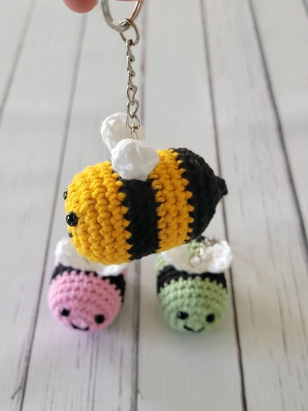 Close up view of yellow crochet bee keychain hanging