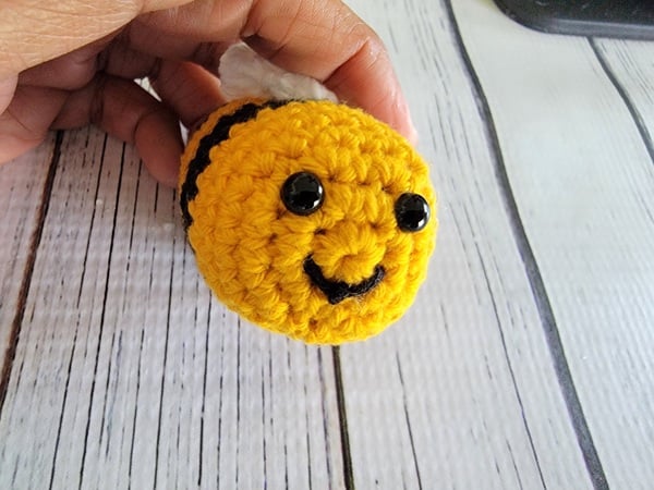 Curved mouth added with black yarn