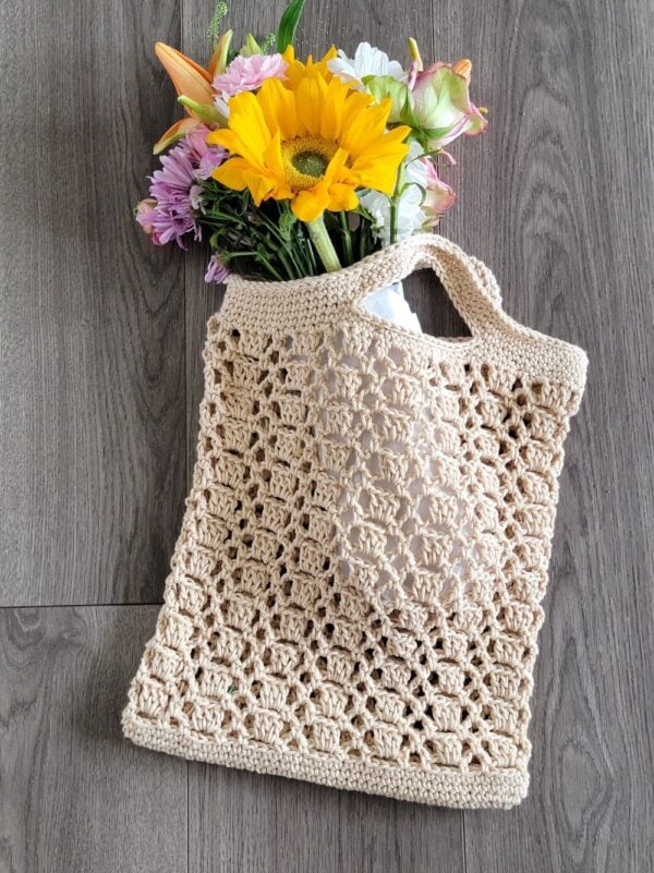 Flowers in a lacy crochet produce bag