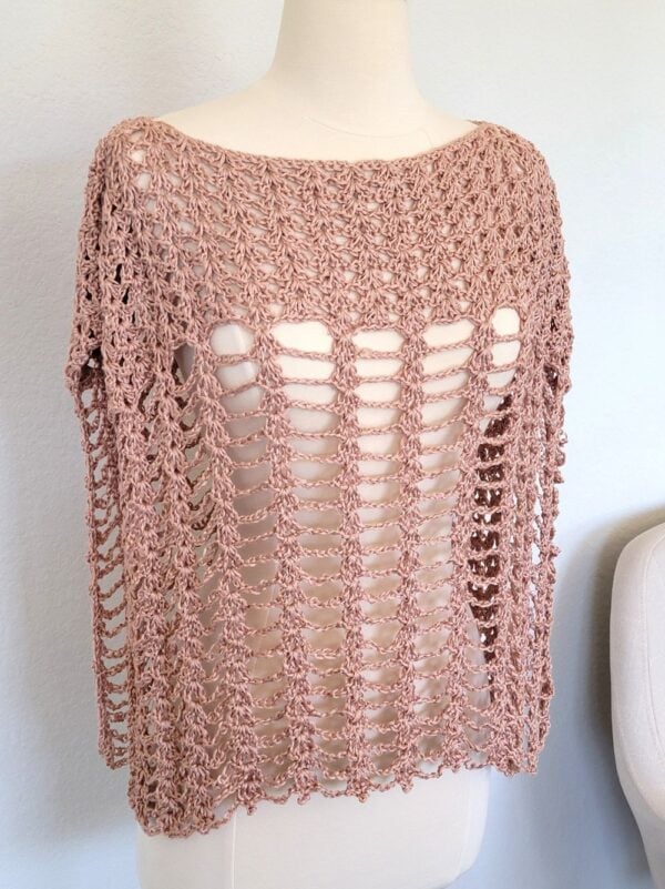 Front view of crochet poncho on a mannequin