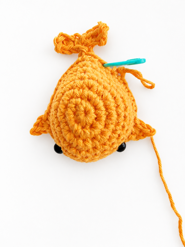 Crochet whale body with fins and safety eyes attached