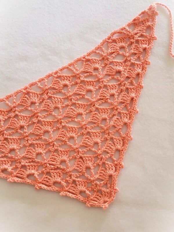 Peach crochet head bandana with a delicate shell stitch lace design, displayed flat on a white background with one tie visible.