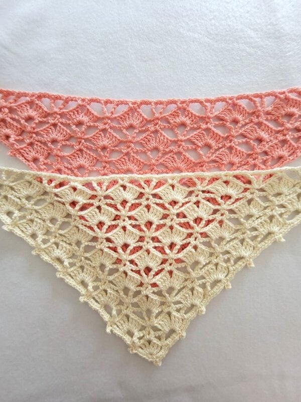 Two handmade crochet bandanas in peach and cream cotton yarn, showing a delicate shell stitch lace design on a white background.
