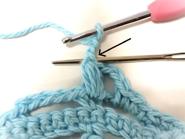 Yarn needle showing where to insert the hook when working a picot stitch