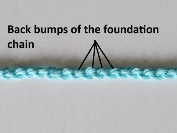 Back bumps of the foundation chain shown with arrows for crochet stitch placement
