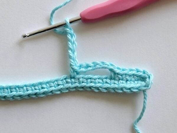 Chain loop being worked along the edge of the crochet headband.