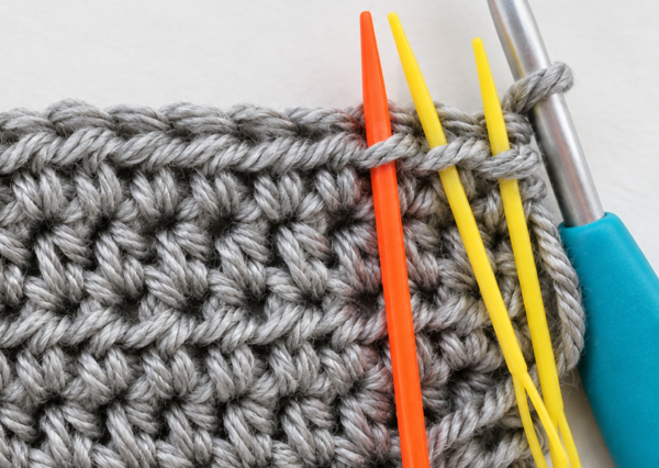Needles inserted into the third loops in front of hdc stitches