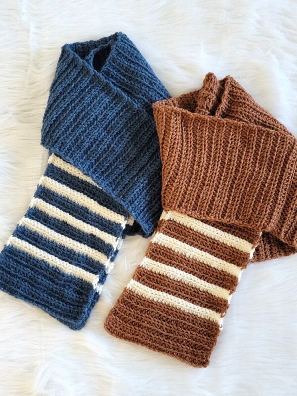 Finished navy and brown crochet scarves featuring textured stitches and contrasting cream stripes.