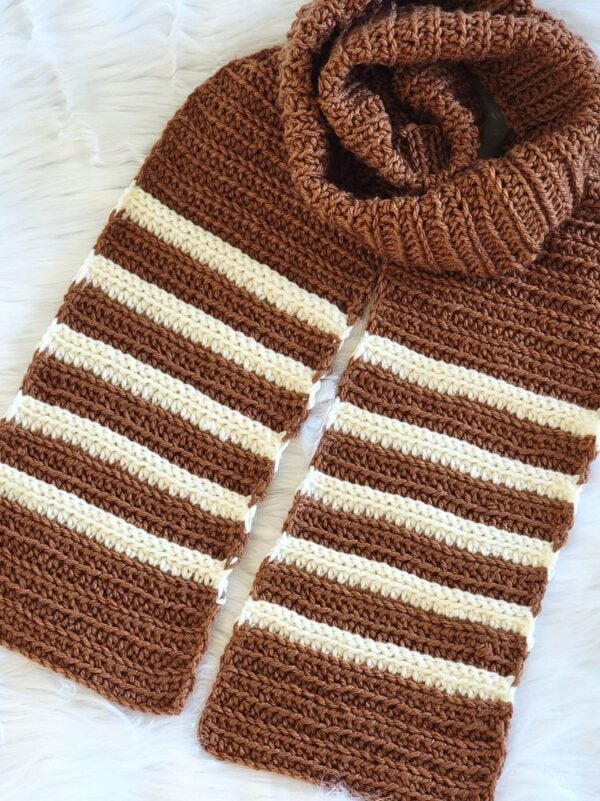 Brown crochet striped scarf with cream accent stripes, showing the textured stitch pattern and finished ends.