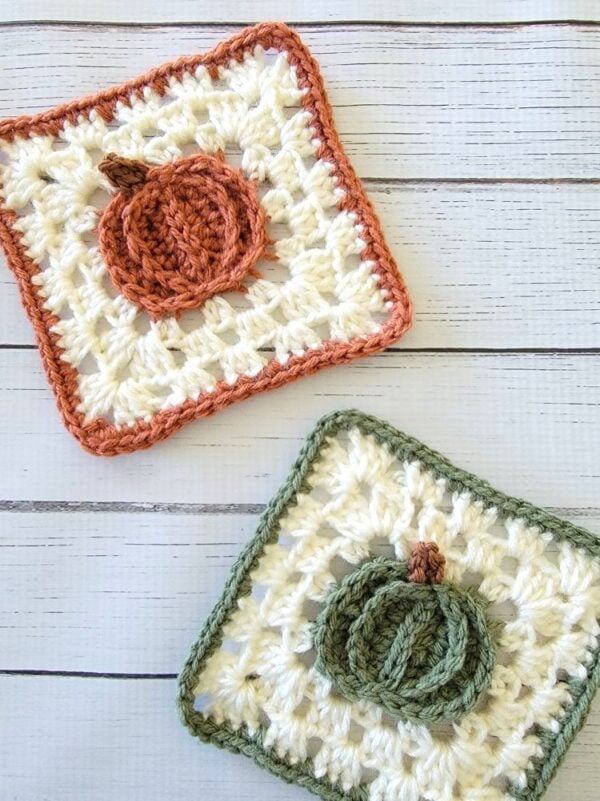 Close-up of orange and green pumpkin crochet coasters showing the raised pumpkin granny square close up.